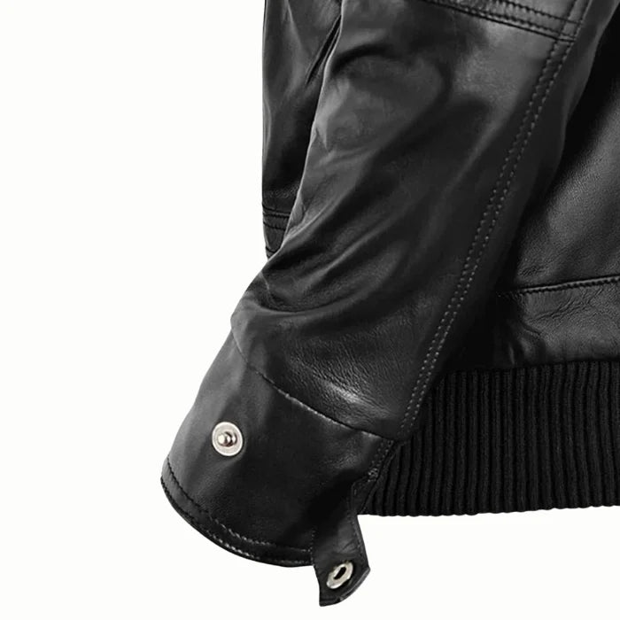 Close-up of a mens black bomber leather jacket with a button