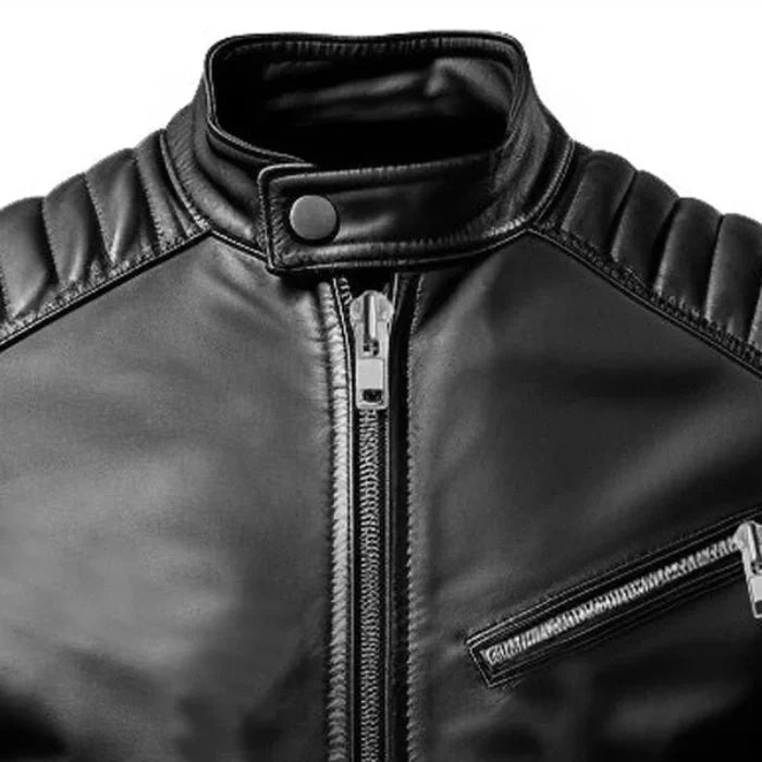 Close-up of a black leather jacket with zippers on a white background