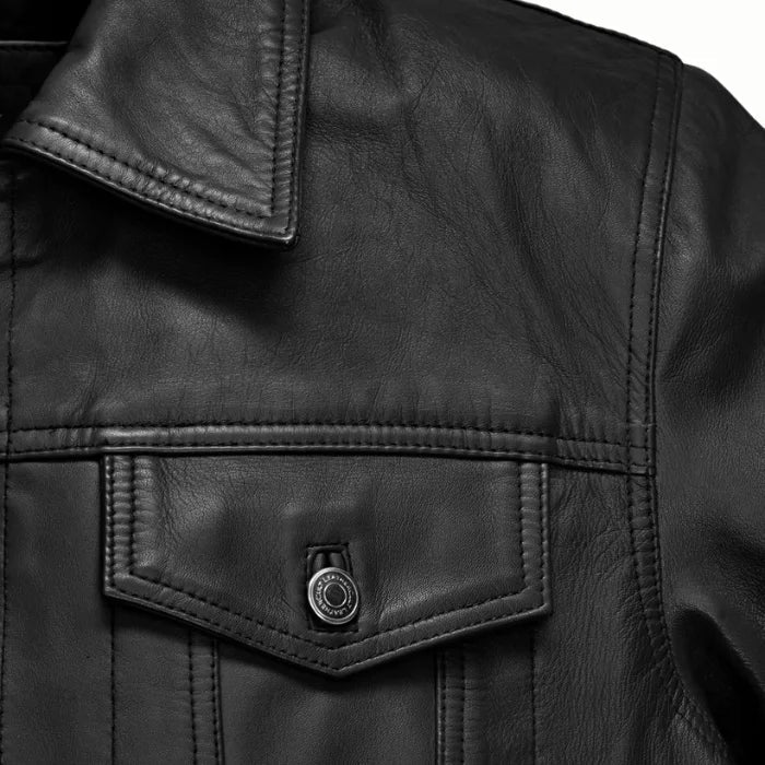 Close-up of a black leather jacket with buttons on a white background